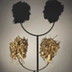Illustration for article titled Gruesome shadow art transforms garbage and mummified rats into severed heads